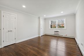 Edison apartment for rent - a living room with white walls and wooden floors and a window