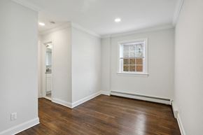 Edison apartment for rent - a living room with white walls and a window and wooden floors
