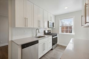 Edison apartment for rent - a kitchen with white cabinets and a sink and a window