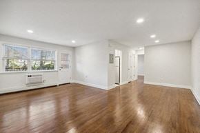 Clark apartment for rent - an empty living room with white walls and wood floors