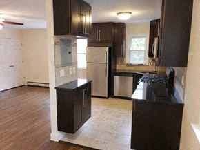 West Caldwell apartment for rent - an empty kitchen with black cabinets and stainless steel appliances