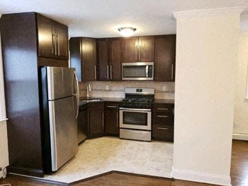 West Caldwell apartment for rent - a kitchen with stainless steel appliances and wooden cabinets