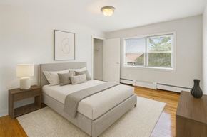 Verona apartment for rent - A bedroom with a large bed and a window overlooking a roof.