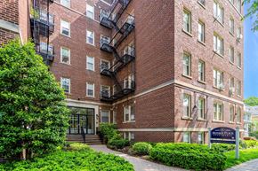 Bloomfield apartment for rent - a brick apartment building with a sidewalk in front of it