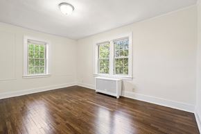 Bloomfield apartment for rent - an empty living room with wood floors and white walls