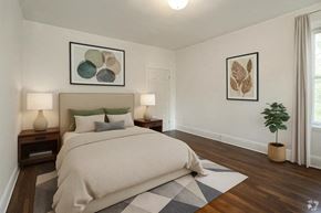 Bloomfield apartment for rent - A bedroom with a large bed and two lamps on nightstands.