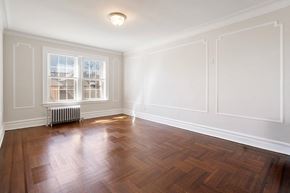 Bloomfield apartment for rent - an empty living room with wood floors and white walls