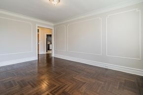 Bloomfield apartment for rent - an empty living room with white walls and wood flooring