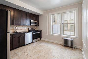 Bloomfield apartment for rent - a kitchen with a stove top oven and a window