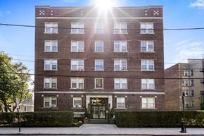 Bloomfield apartment for rent - a brick apartment building with the sun shining in front of it
