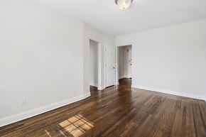 Bloomfield apartment for rent - a living room with hardwood floors and white walls