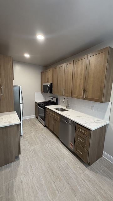 Jersey City apartment for rent - A kitchen with wooden cabinets and a white countertop.