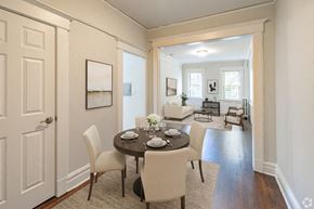 Bloomfield apartment for rent - A dining room with a table set for two and chairs around it.