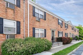 Bloomfield apartment for rent - a brick building with black windows and a sidewalk