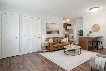 Bloomfield apartment for rent - A living room with a brown couch and a white rug.