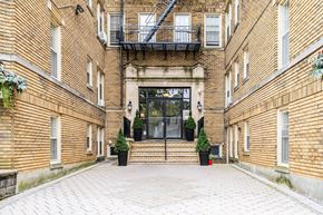 Bloomfield apartment for rent - the entrance of a brick building with a glass door