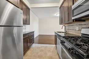 Bloomfield apartment for rent - a kitchen with stainless steel appliances and wooden cabinets