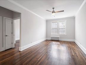 Kearny apartment for rent - an empty living room with wood floors and a ceiling fan