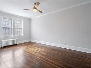 Kearny apartment for rent - an empty living room with wood floors and a ceiling fan