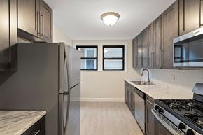 Kearny apartment for rent - an empty kitchen with stainless steel appliances and marble counter tops