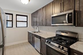 Kearny apartment for rent - a kitchen with stainless steel appliances and wooden cabinets