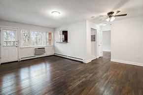 Matawan apartment for rent - an empty living room with wood floors and a ceiling fan