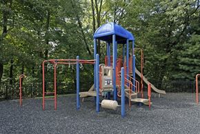 Matawan apartment for rent - a playground with a blue swing set and other playground equipment