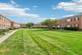 Woodbridge apartment for rent - A grassy area in front of apartment buildings.