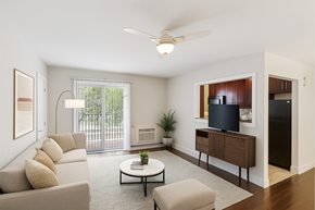 Colonia apartment for rent - A living room with a couch, a coffee table, a television, and a ceiling fan.