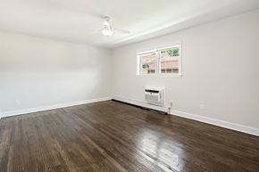 Woodbridge apartment for rent - an empty living room with wood flooring and a window