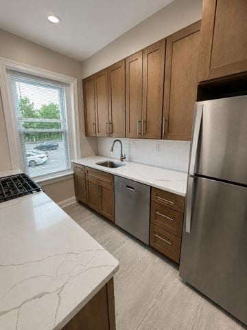 Short Hills apartment for rent - A kitchen with a marble counter top and stainless steel appliances.