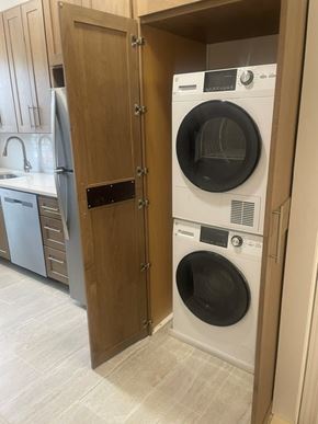 Short Hills apartment for rent - A white dryer is in a wooden door.