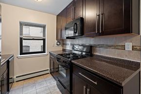Hackensack apartment for rent - a kitchen with a stove and a microwave