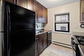 Hackensack apartment for rent - a kitchen with a black refrigerator and a window