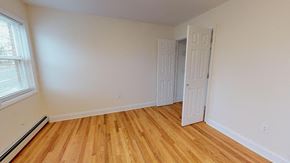 Belleville apartment for rent - a room with a wooden floor and an open door