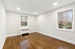 Belleville apartment for rent - an empty living room with wood flooring and two windows