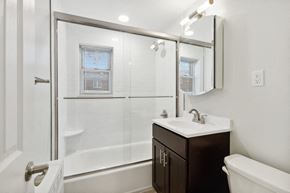 Belleville apartment for rent - a white bathroom with a shower and a sink