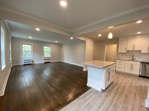 Tenafly apartment for rent - an open kitchen and living room with a center island