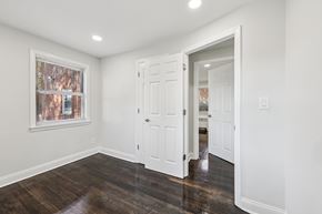 West Orange apartment for rent - A room with a white door and a window with a view of a brick building.