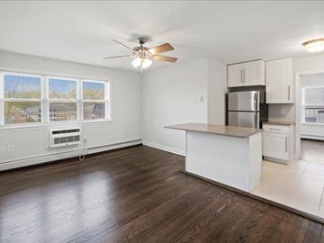 Caldwell apartment for rent - A kitchen with white cabinets and a wooden floor.