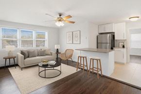 Caldwell apartment for rent - A modern living room with a kitchen area in the background.