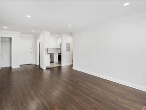 Caldwell apartment for rent - A spacious room with wooden floors and white walls.