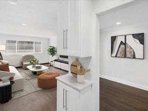 Caldwell apartment for rent - A modern kitchen with white cabinets and a wooden counter.