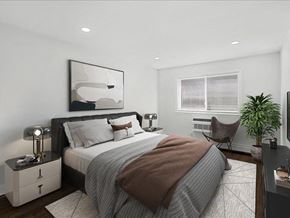 Caldwell apartment for rent - A modern bedroom with a large bed and a large mirror on the wall.