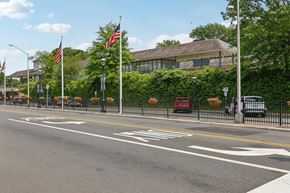 Cranford apartment for rent - A street with a white line in the middle and a building in the background.