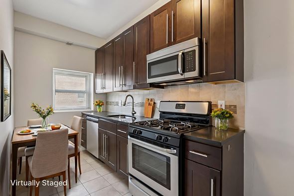 Cranford apartment for rent - A kitchen with a stove top oven and microwave.