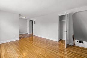 Long Branch apartment for rent - a living room with a hard wood floor and a door to a hallway