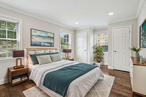 Summit apartment for rent - A bedroom with a large bed and a painting on the wall.