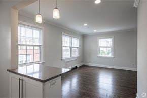 Summit apartment for rent - an empty kitchen with white cabinets and a counter top