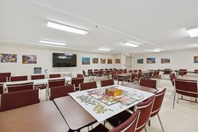 Livingston apartment for rent - a conference room with tables and chairs and a television